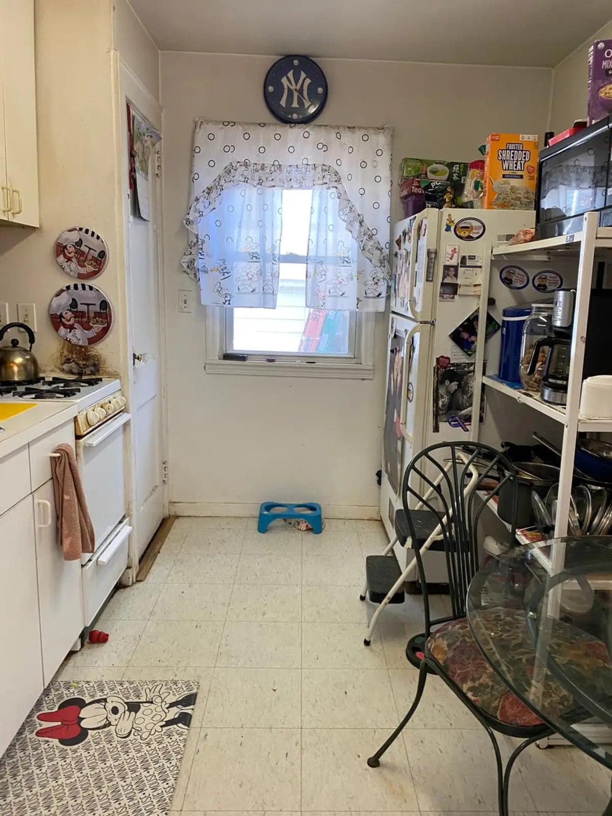 Selling a house with unpermitted work in Babylon: narrow galley kitchen with white cabinets