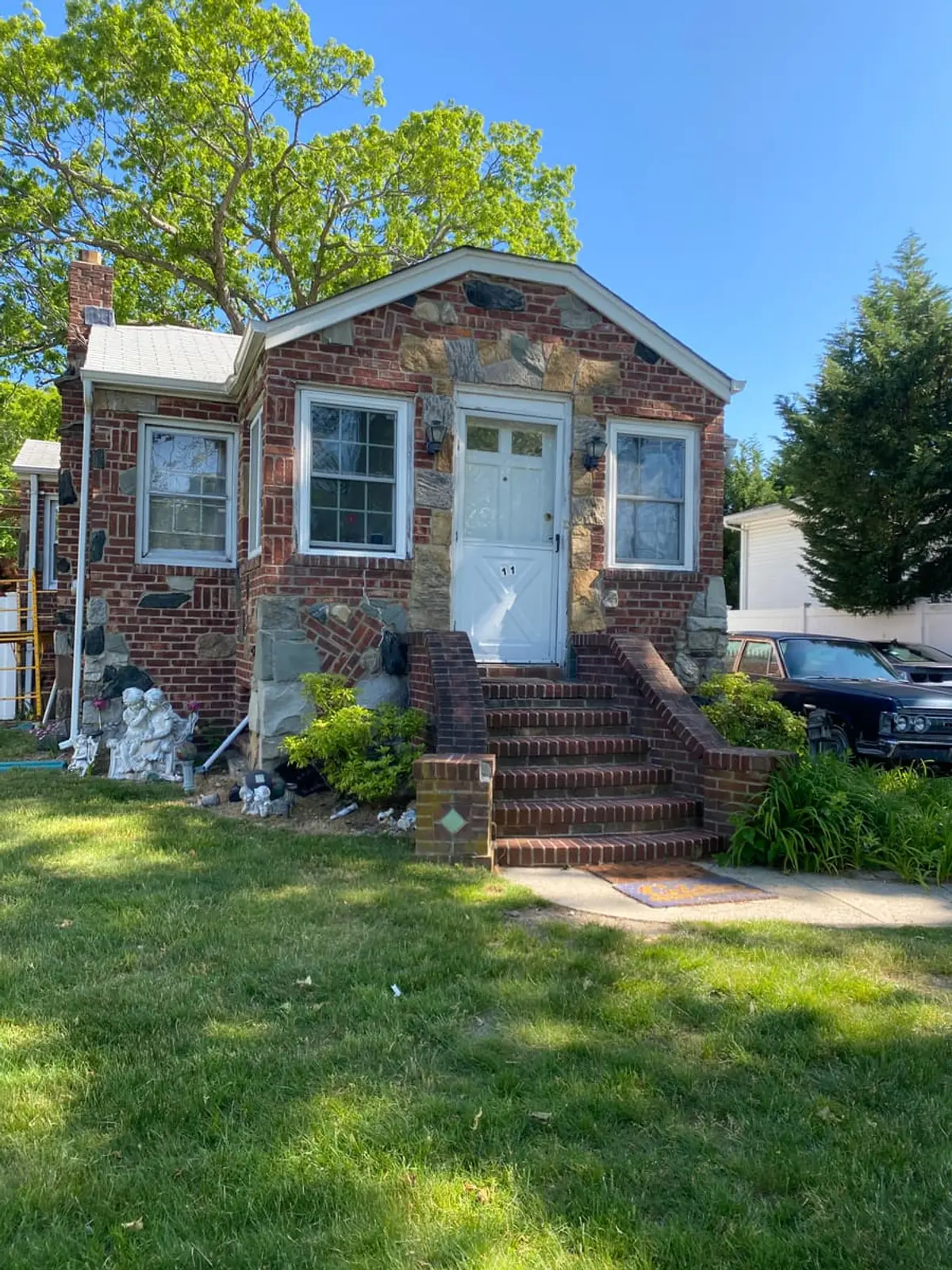 Trying to stop a foreclosure in Babylon: small brick and stone cottage with a front stoop
